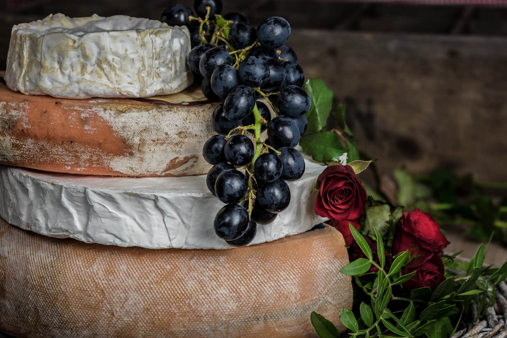 Grapes and roses over artisan cheese