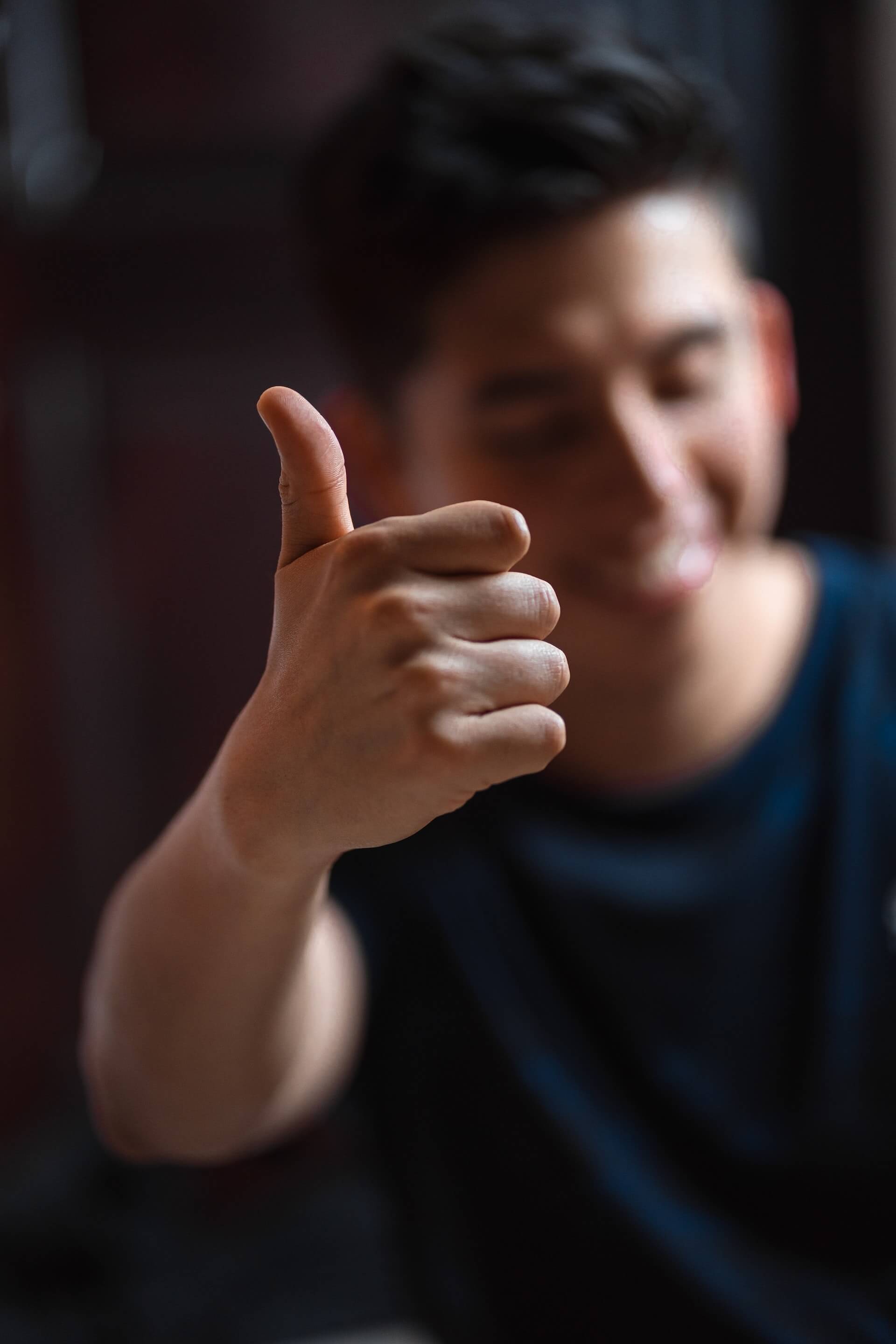 Young man giving a thumbs up